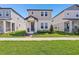 Charming two-story home with a well-manicured front lawn and inviting entryway at 5217 Passion Flower Way, Winter Garden, FL 34787