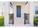 Close-up of the home's entrance highlighting the blue front door and covered porch at 5217 Passion Flower Way, Winter Garden, FL 34787