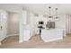 Modern kitchen with white cabinets, stainless steel appliances, and an island with pendant lighting at 5217 Passion Flower Way, Winter Garden, FL 34787