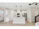 Modern kitchen featuring a central island, stainless appliances, and sleek white cabinetry at 5217 Passion Flower Way, Winter Garden, FL 34787