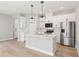 Bright kitchen featuring stainless steel appliances, a center island, and stylish pendant lighting at 5217 Passion Flower Way, Winter Garden, FL 34787