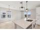 Open-concept kitchen with a view of a chandelier over the dining area, and large windows at 5217 Passion Flower Way, Winter Garden, FL 34787