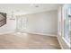 Bright living room with large windows, modern lighting, and beautiful wood flooring at 5217 Passion Flower Way, Winter Garden, FL 34787
