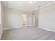 A spacious carpeted primary bedroom features neutral paint, base trim and an attached primary bathroom at 5217 Passion Flower Way, Winter Garden, FL 34787