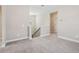 Open upstairs landing with neutral carpet, railing overlooking the staircase, and access to bedrooms at 5217 Passion Flower Way, Winter Garden, FL 34787