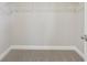 A neutral toned carpeted walk-in closet features white wire shelving and base trim at 5217 Passion Flower Way, Winter Garden, FL 34787