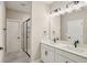 Bathroom featuring double sinks, black fixtures, and a glass-enclosed shower at 5235 Passion Flower Way, Winter Garden, FL 34787