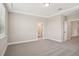 Bedroom with neutral walls, carpeted floors, and a door to the bathroom at 5235 Passion Flower Way, Winter Garden, FL 34787