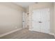This bedroom features neutral walls, carpet, and a large double door closet with modern hardware at 5235 Passion Flower Way, Winter Garden, FL 34787