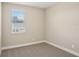 A serene bedroom with soft, neutral walls, plush carpeting, and a window offering natural light at 5235 Passion Flower Way, Winter Garden, FL 34787