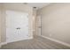 A clean bedroom features neutral walls, soft carpeting, and a large closet with modern hardware at 5235 Passion Flower Way, Winter Garden, FL 34787