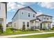 Charming two-story home with blue siding, stone accents, and a well-maintained front yard at 5235 Passion Flower Way, Winter Garden, FL 34787