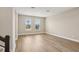 Light-filled living area featuring wood floors, large windows, and neutral wall color at 5235 Passion Flower Way, Winter Garden, FL 34787
