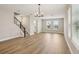 Bright living area with wood floors, stairs, and large windows offering plenty of natural light at 5235 Passion Flower Way, Winter Garden, FL 34787