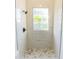 Modern tiled shower with rainfall showerhead and mosaic tile floor at 6550 Cartmel Ln, Windermere, FL 34786