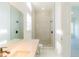 Modern bathroom with glass shower, white marble tile, and sleek fixtures at 6550 Cartmel Ln, Windermere, FL 34786