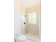 Modern bathroom featuring a walk-in shower with decorative floor and marble-look walls at 6550 Cartmel Ln, Windermere, FL 34786