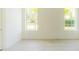 Bedroom with light hardwood flooring and two large windows for natural light at 6550 Cartmel Ln, Windermere, FL 34786