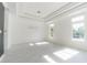 Bright bedroom with light wood floors, tray ceiling and windows with backyard views at 6550 Cartmel Ln, Windermere, FL 34786
