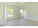 Bedroom with light hardwood flooring and lots of natural light from two large windows at 6550 Cartmel Ln, Windermere, FL 34786