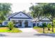 Beautiful single-Gathering home with palm trees and a well maintained lawn and a brick driveway at 6550 Cartmel Ln, Windermere, FL 34786