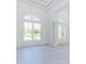 Bright foyer with high ceilings, light floors, column, and double door entry at 6550 Cartmel Ln, Windermere, FL 34786