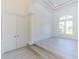 Bright foyer with high ceilings, light floors, column, and double door entry at 6550 Cartmel Ln, Windermere, FL 34786