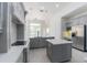 Modern kitchen with gray cabinets, stainless appliances, and quartz countertops at 6550 Cartmel Ln, Windermere, FL 34786