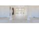 Bright and spacious living room with modern lighting, columns, multiple french doors, and neutral-toned walls at 6550 Cartmel Ln, Windermere, FL 34786