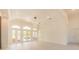 Bright, airy living room with coffered ceilings and multiple French doors to outdoor area at 6550 Cartmel Ln, Windermere, FL 34786