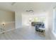 Bright living room features hardwood flooring, large windows, and a striped sofa at 6550 Cartmel Ln, Windermere, FL 34786