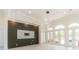 Open living room featuring decorative wall paneling, modern light fixture, and French doors at 6550 Cartmel Ln, Windermere, FL 34786