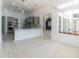 Open living space with kitchen view, light wood floors, and modern finishes at 6550 Cartmel Ln, Windermere, FL 34786