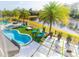 Aerial view of a beautiful kidney-shaped pool, spa, and patio overlooking a tranquil pond at 6550 Cartmel Ln, Windermere, FL 34786