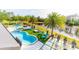 Aerial view of a stunning kidney-shaped pool, spa, and deck overlooking a scenic pond at 6550 Cartmel Ln, Windermere, FL 34786