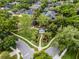 An aerial view of the community park, playground, and neighborhood streets lined with mature trees at 889 Kensington Gardens Ct, Oviedo, FL 32765