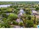 Aerial view of home with a pool in the backyard and surrounded by mature trees and partial red line at 889 Kensington Gardens Ct, Oviedo, FL 32765