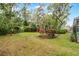 Grassy backyard surrounded by trees and landscaping providing privacy to this outside oasis at 889 Kensington Gardens Ct, Oviedo, FL 32765