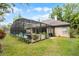 Screened-in pool with a view of the backyard that is surrounded by a garden and a privacy fence at 889 Kensington Gardens Ct, Oviedo, FL 32765