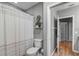 Bathroom showcasing a toilet, shower with curtain, and shelving at 889 Kensington Gardens Ct, Oviedo, FL 32765