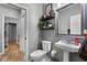 Stylish bathroom with a toilet, pedestal sink, and decorative shelves at 889 Kensington Gardens Ct, Oviedo, FL 32765