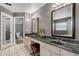 Bathroom with double sinks, marble countertops, modern lighting, and tiled floors at 889 Kensington Gardens Ct, Oviedo, FL 32765