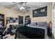 Cozy bedroom with large bed, ceiling fan, and UCF Big 12 banner at 889 Kensington Gardens Ct, Oviedo, FL 32765