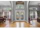 Grand entryway with double doors, high ceilings, large windows, and wood flooring providing a bright, welcoming atmosphere at 889 Kensington Gardens Ct, Oviedo, FL 32765