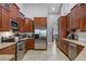Well-appointed kitchen with stainless steel appliances, light countertops, dark wood cabinets, and tiled flooring at 889 Kensington Gardens Ct, Oviedo, FL 32765
