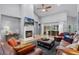 Bright living room featuring a fireplace, vaulted ceilings, hardwood floors, and sliding glass doors to an outdoor patio at 889 Kensington Gardens Ct, Oviedo, FL 32765