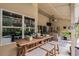 Covered patio with bar and seating area overlooking the pool at 889 Kensington Gardens Ct, Oviedo, FL 32765