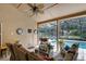 Covered patio with wicker furniture overlooking a sparkling swimming pool at 889 Kensington Gardens Ct, Oviedo, FL 32765