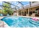 Enclosed pool area with hot tub, seating, and covered patio at 889 Kensington Gardens Ct, Oviedo, FL 32765