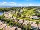 Aerial view of the property within a vibrant community, near a golf course, a lake, and winding roads at 10033 Hart Branch Cir, Orlando, FL 32832